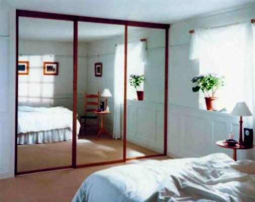 Mirrored Wardrobes in bedroom dark wood