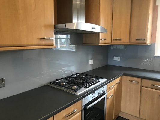 Grey glass splash back installed in a kitchen